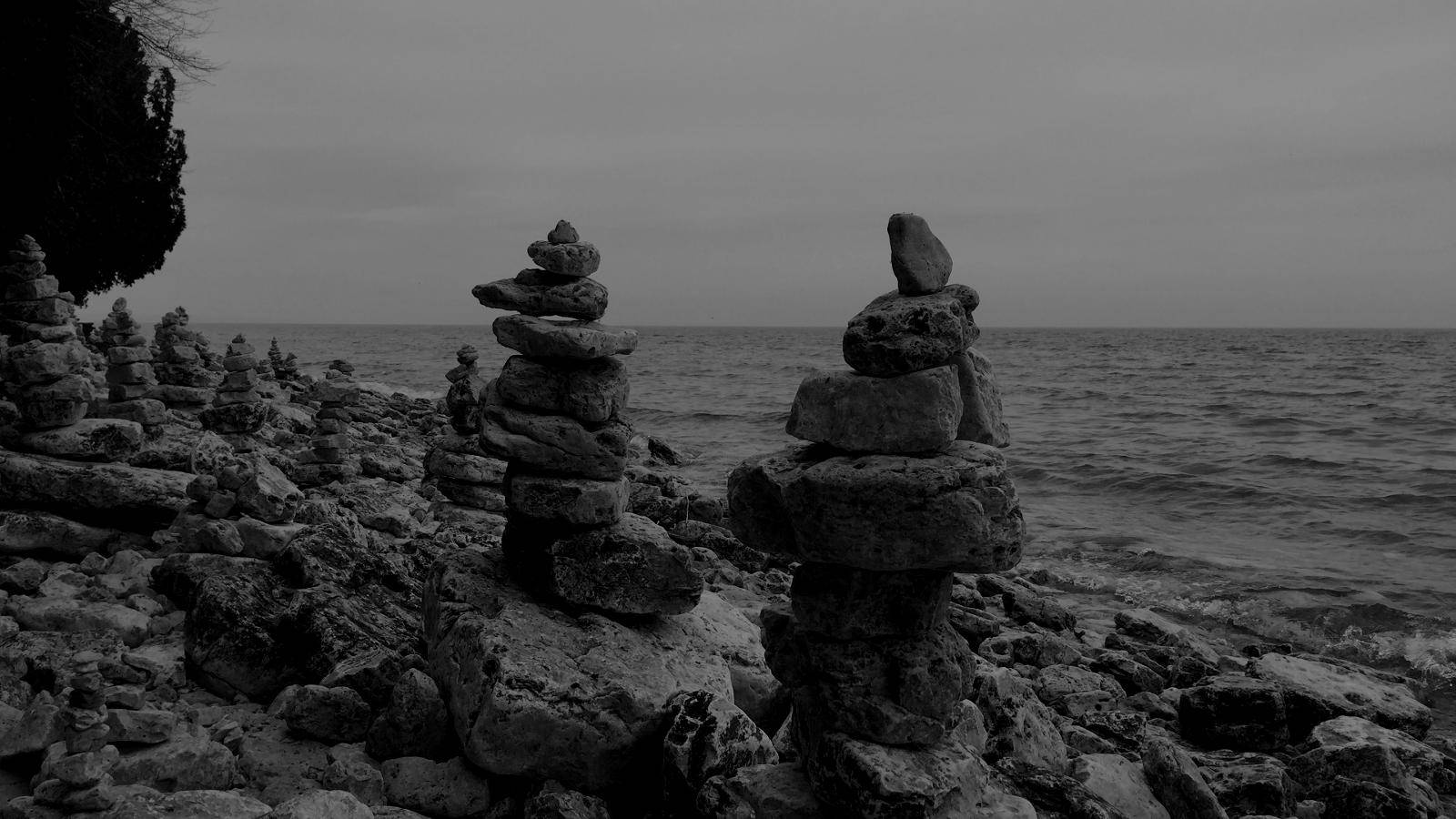 A lot of cairns on a beach.